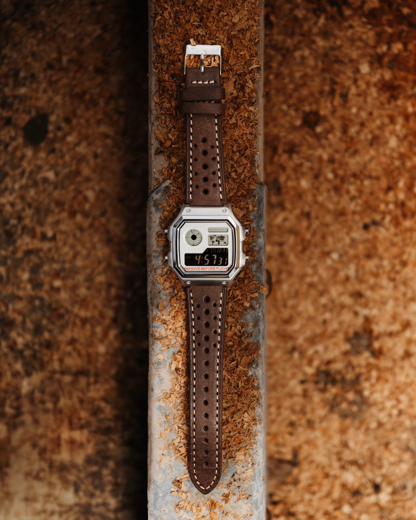 Vintage-style watch with brown leather strap on a rusty metal surface
Pilot Royale Metal AE-1200 - Modified Casio Watch - by eon time - ura watches