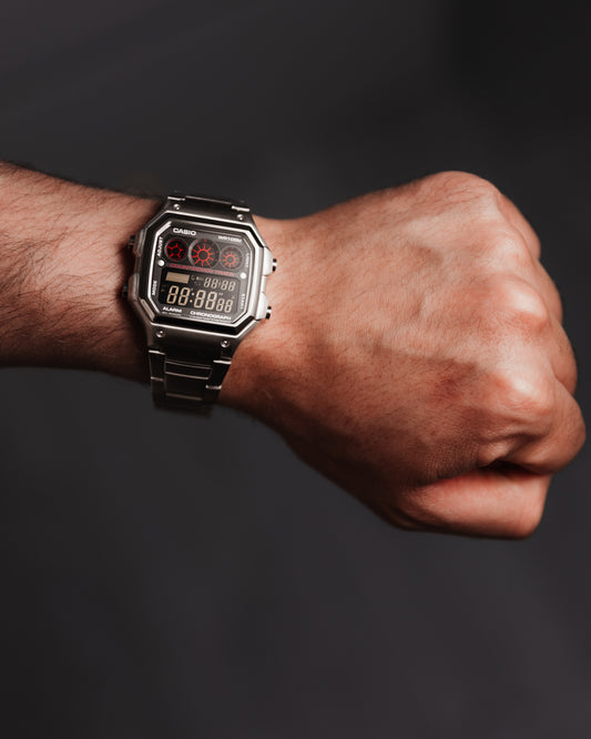 EON Redline Full Metal AE-1300 custom Casio digital watch with red and black display, stainless steel case and bracelet, worn on wrist.
