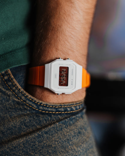 NASA F-91 custom Casio watch with white case and orange strap worn on wrist