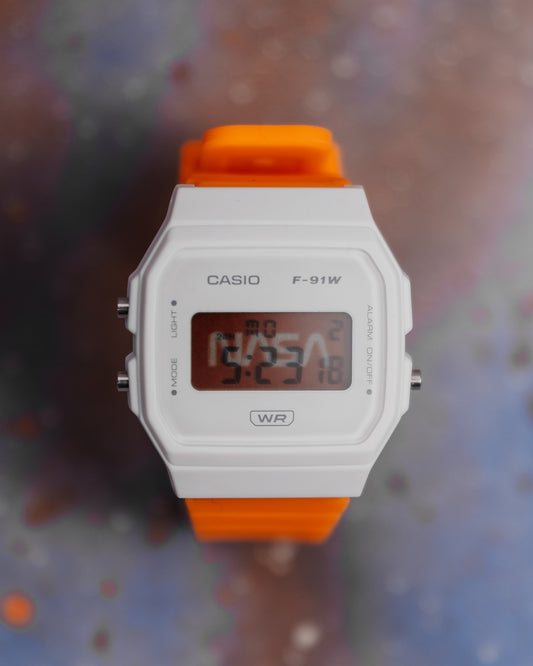 NASA F-91 modified Casio F-91W watch with white case, orange strap and NASA inspired display